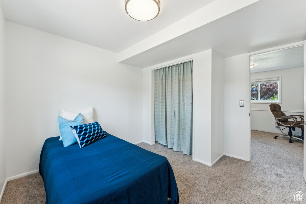 Bedroom with carpet floors and baseboards