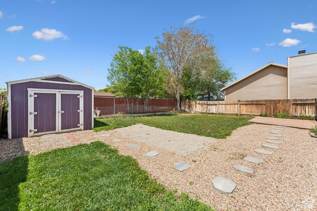View of yard featuring a storage shed and an outbuilding
