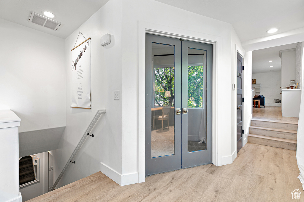 Doorway to outside with french doors, wood finished floors, visible vents, recessed lighting, and baseboards