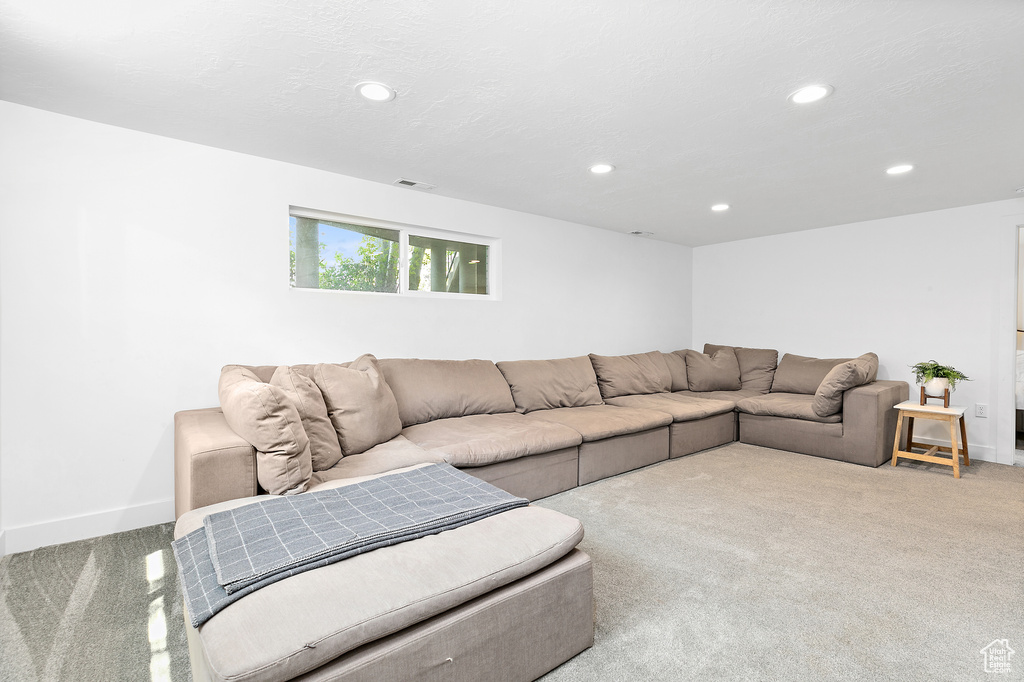 Living area featuring recessed lighting, visible vents, baseboards, and carpet floors