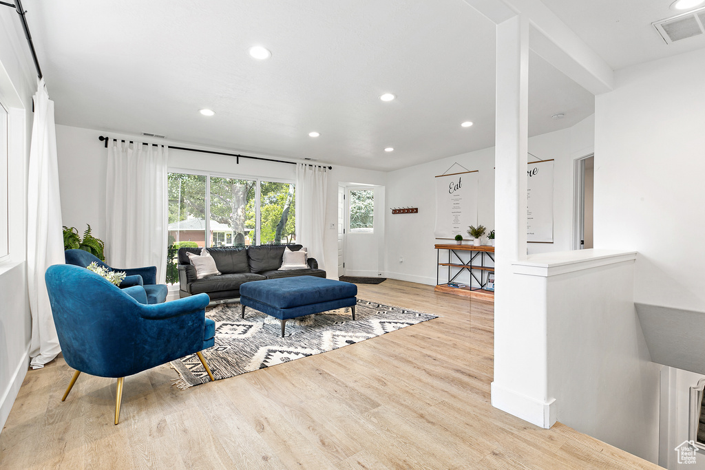 Living area featuring recessed lighting, baseboards, visible vents, and wood finished floors
