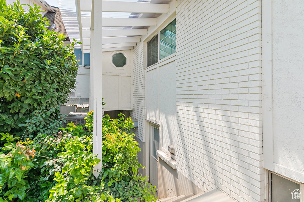 View of property exterior with brick siding