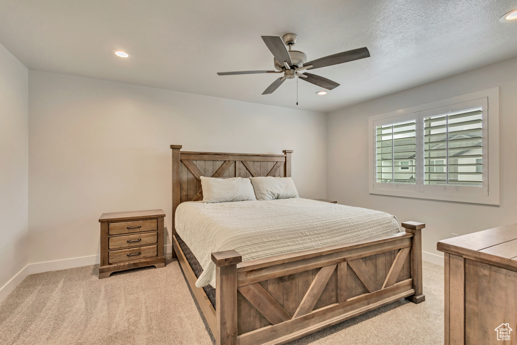 Bedroom featuring light carpet, baseboards, recessed lighting, and a ceiling fan
