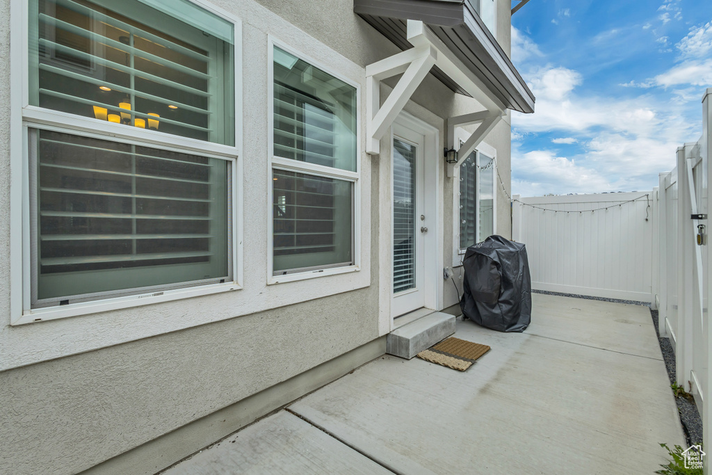 View of patio featuring a grill and fence