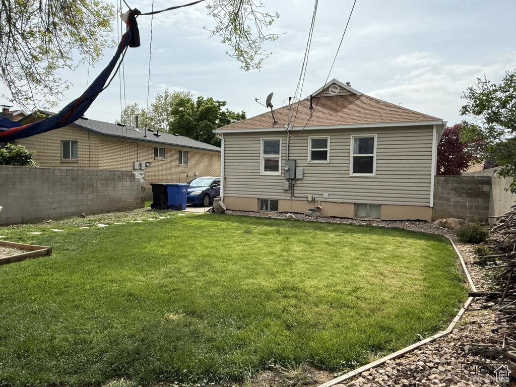 Back of property with roof with shingles