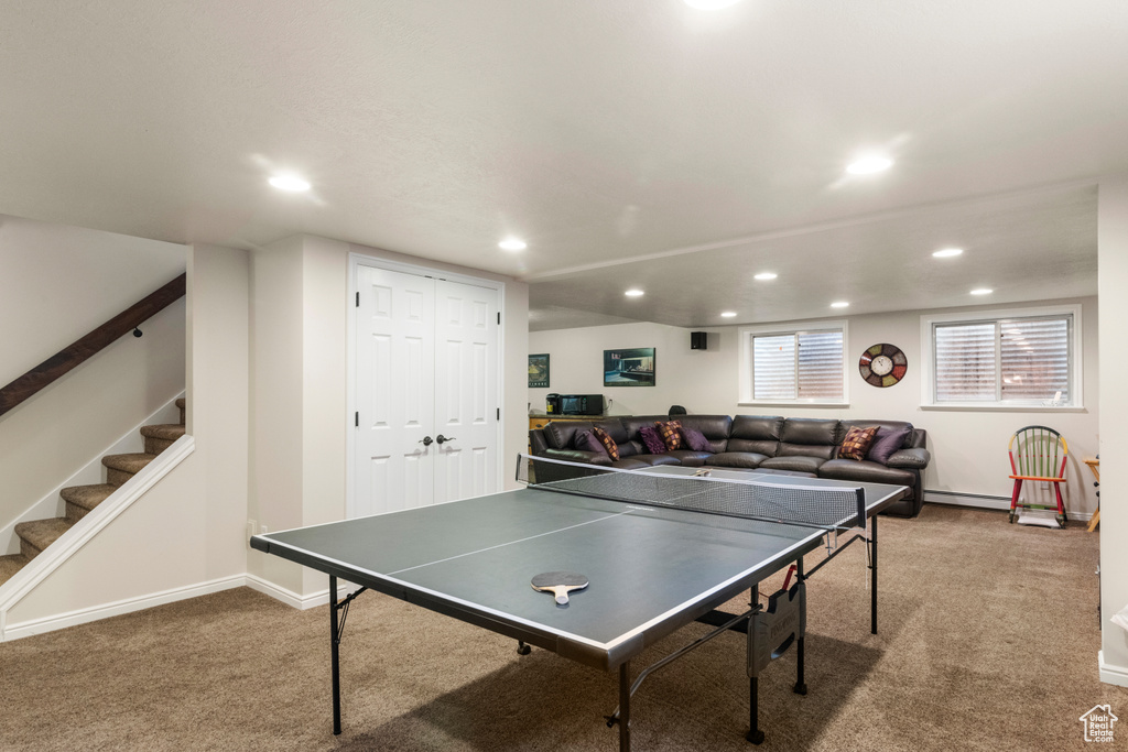 Playroom featuring carpet floors, recessed lighting, baseboards, and baseboard heating