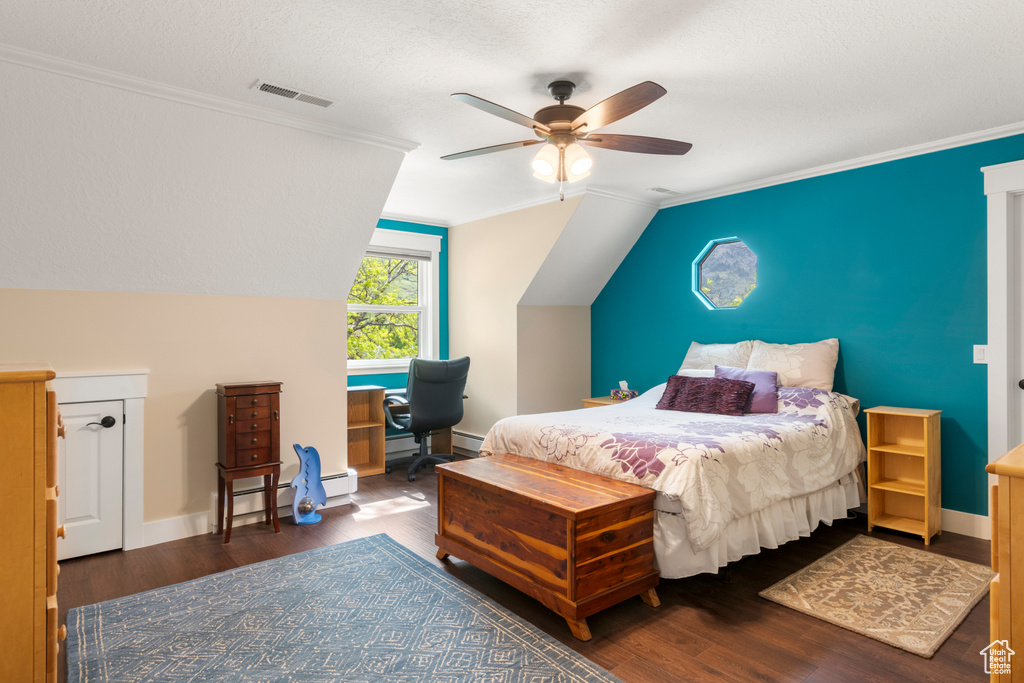 Bedroom featuring wood finished floors, vaulted ceiling, ceiling fan, a baseboard heating unit, and ornamental molding