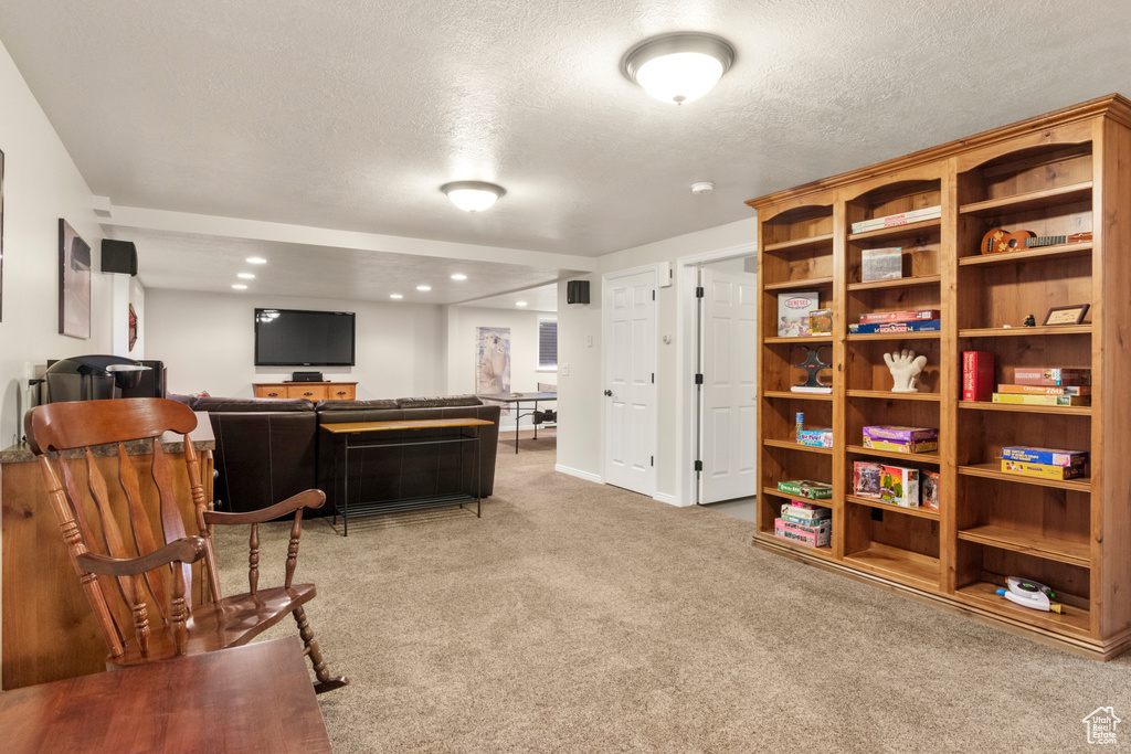 Sitting room featuring carpet floors, a textured ceiling, recessed lighting, and baseboards