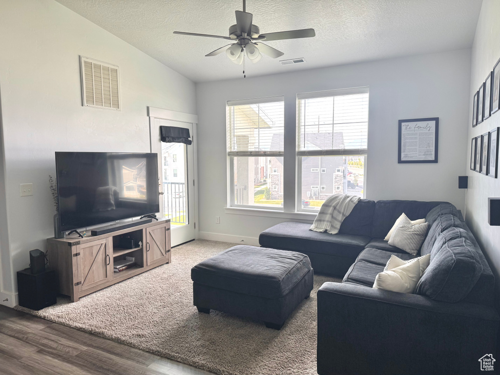 Living area featuring ceiling fan, a wealth of natural light, and visible vents