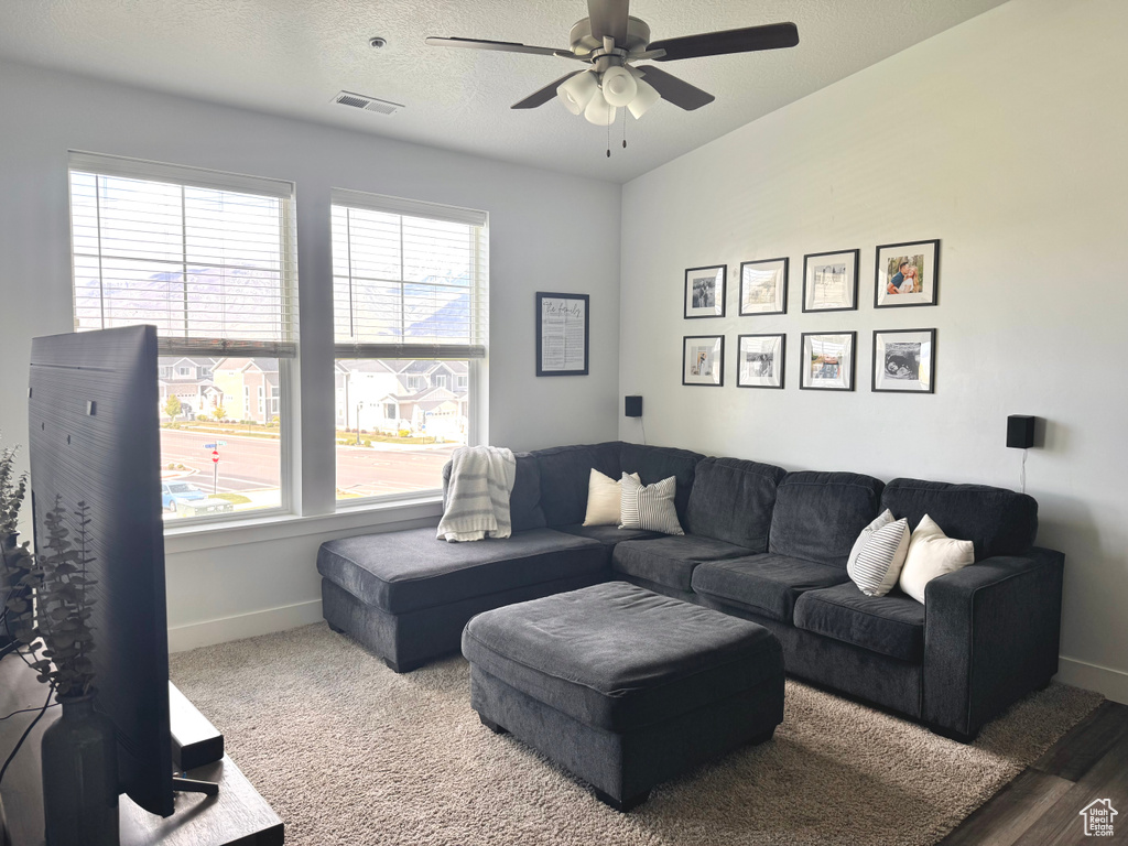 Living room with a wealth of natural light, baseboards, and visible vents