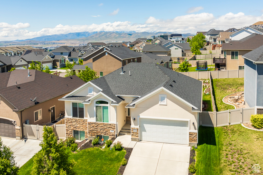 Aerial perspective of suburban area featuring a mountain backdrop