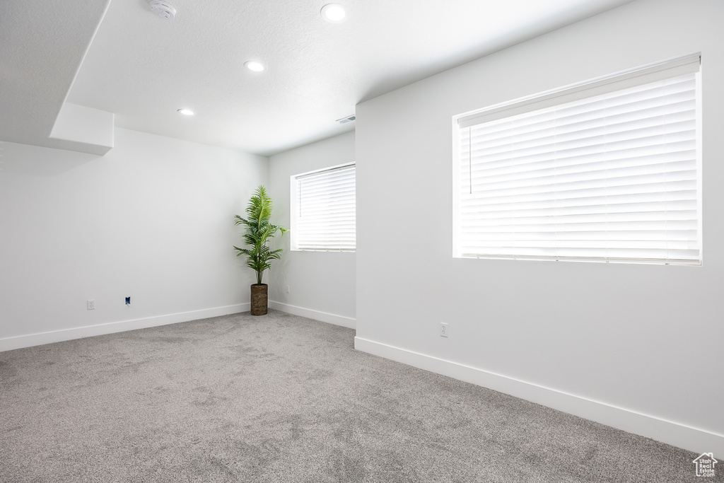 Spare room with carpet floors, recessed lighting, baseboards, and a smoke detector
