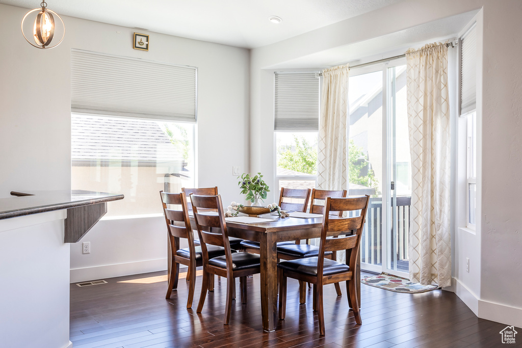 Dining space featuring plenty of natural light, wood finished floors, and baseboards