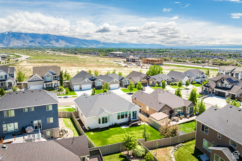 Aerial view of residential area featuring a mountainous background