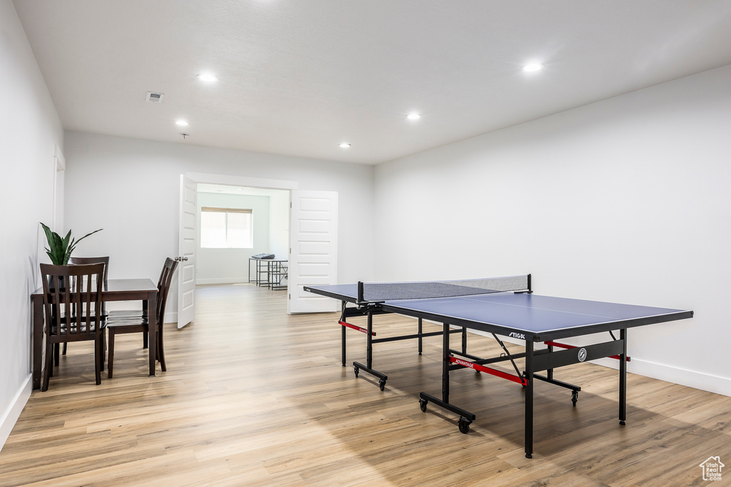 Game room with light wood finished floors, recessed lighting, and baseboards