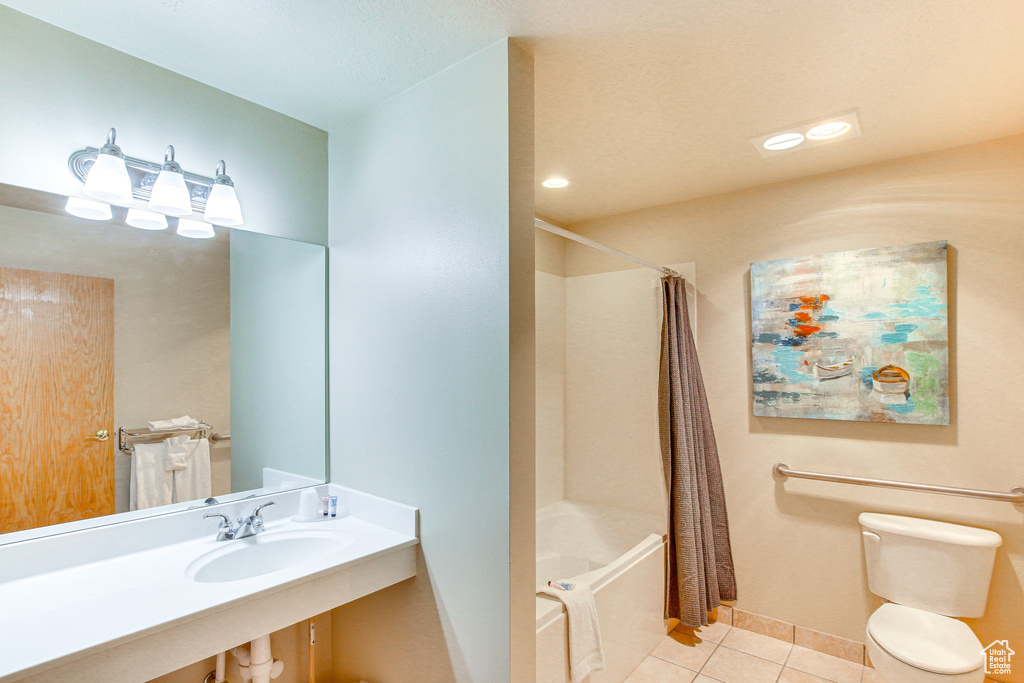 Bathroom with toilet, baseboards, tile patterned floors, and shower / bath combination with curtain