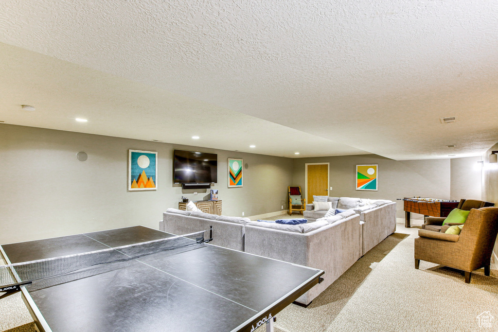 Playroom with recessed lighting, a textured ceiling, and carpet floors