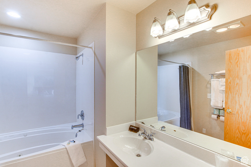 Full bathroom featuring vanity and shower / bath combo with shower curtain