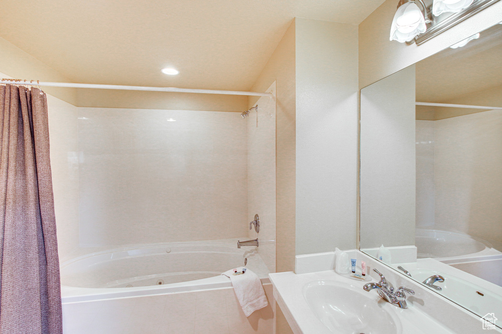 Full bathroom with shower / bath combination with curtain, vanity, and recessed lighting