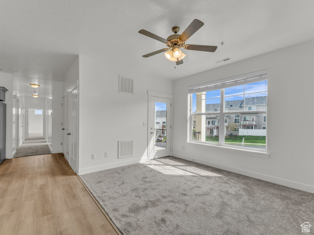 Empty room featuring baseboards and ceiling fan
