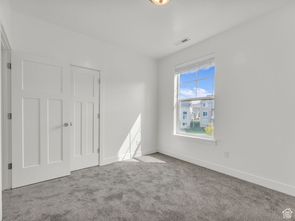 Unfurnished bedroom featuring carpet floors and baseboards
