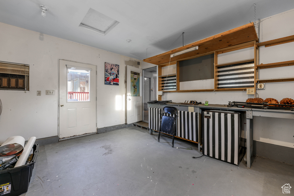 Miscellaneous room with concrete floors and attic access