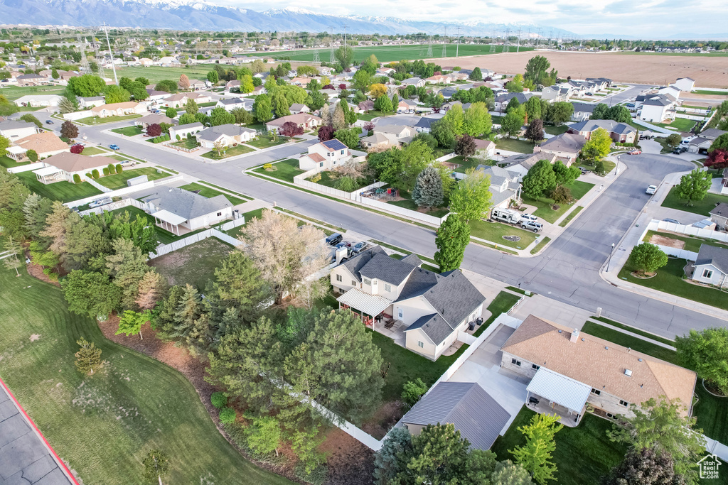 Aerial perspective of suburban area featuring a mountainous background