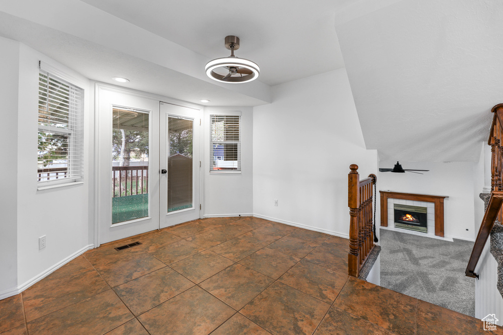 Unfurnished dining area featuring baseboards, a tile fireplace, and recessed lighting