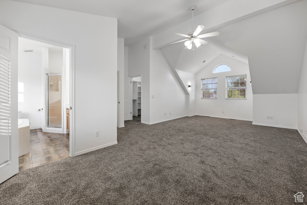Additional living space featuring carpet, a ceiling fan, vaulted ceiling, and baseboards