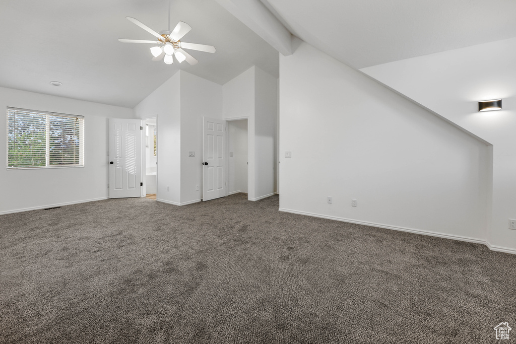 Additional living space with carpet floors, ceiling fan, baseboards, and high vaulted ceiling