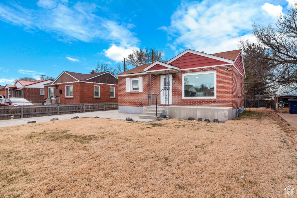 Bungalow-style house with brick siding