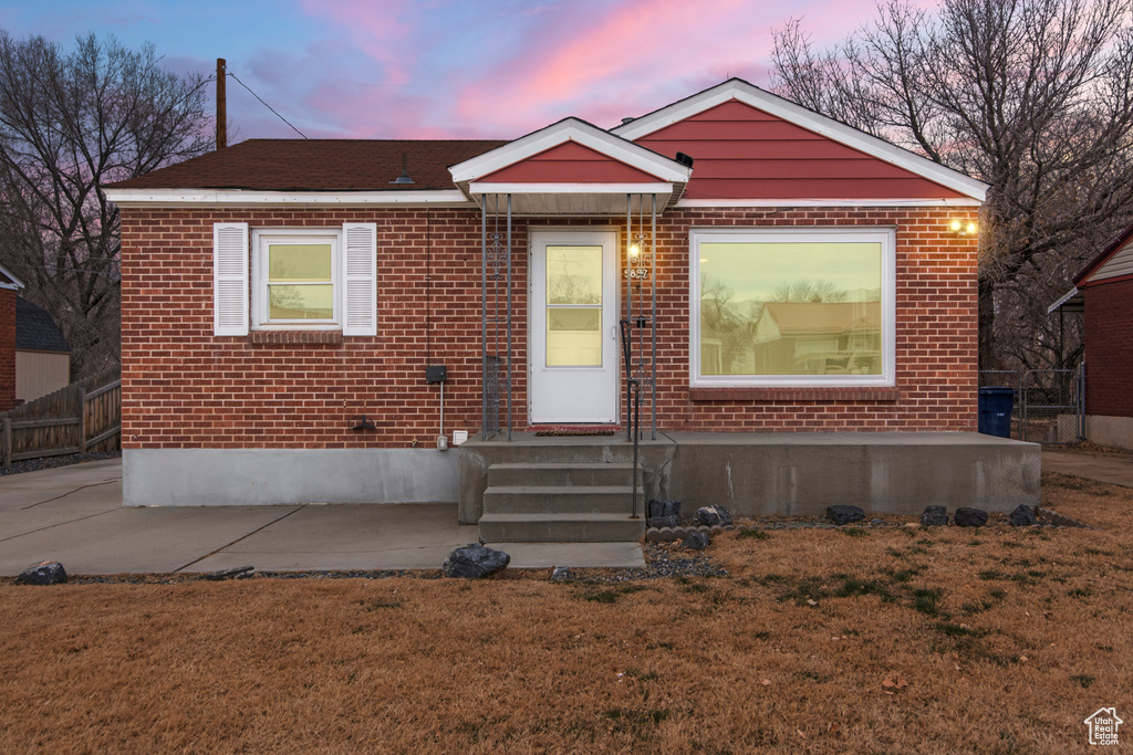 Bungalow-style house featuring brick siding and entry steps