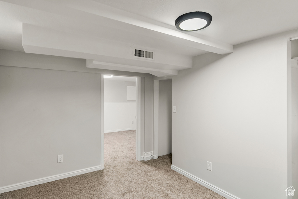 Finished below grade area featuring carpet floors and baseboards