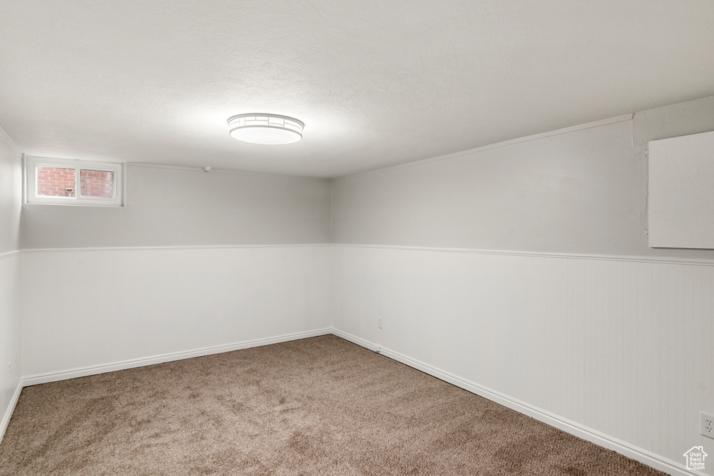 Carpeted spare room with baseboards