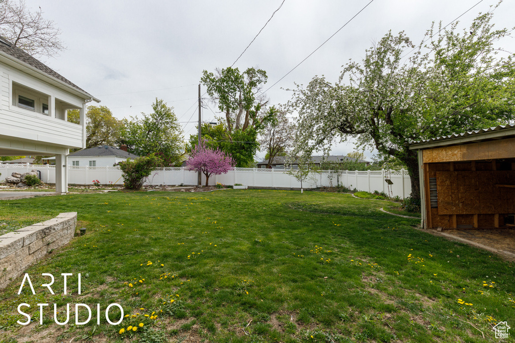 View of yard featuring fence