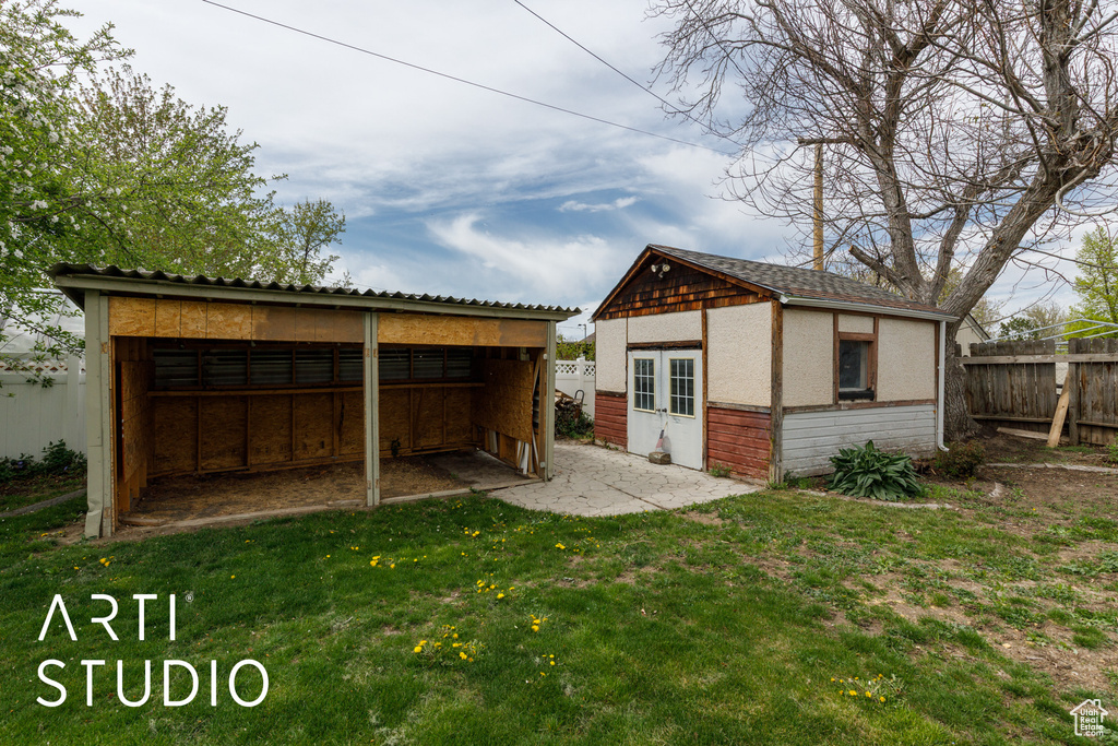 View of outbuilding featuring an outdoor structure and fence