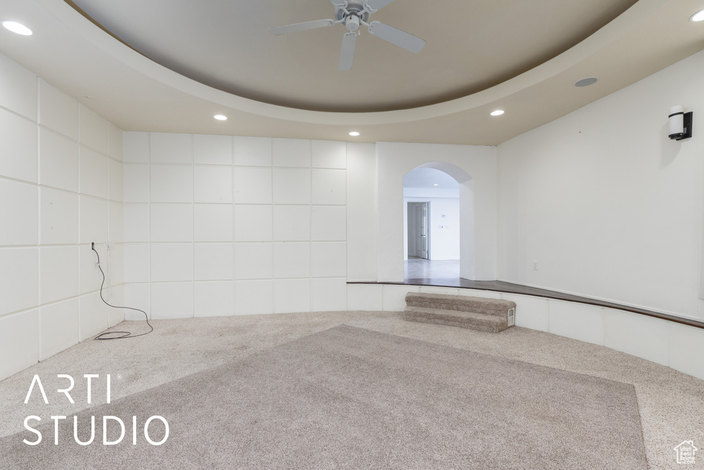 Spare room featuring carpet floors, arched walkways, a ceiling fan, and recessed lighting