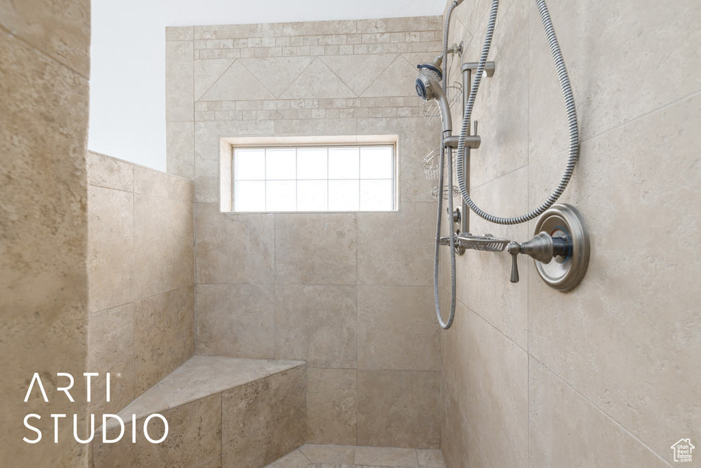 Full bath featuring a tile shower