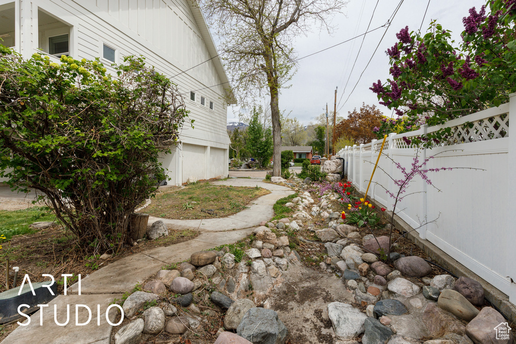 View of yard with a garage and fence