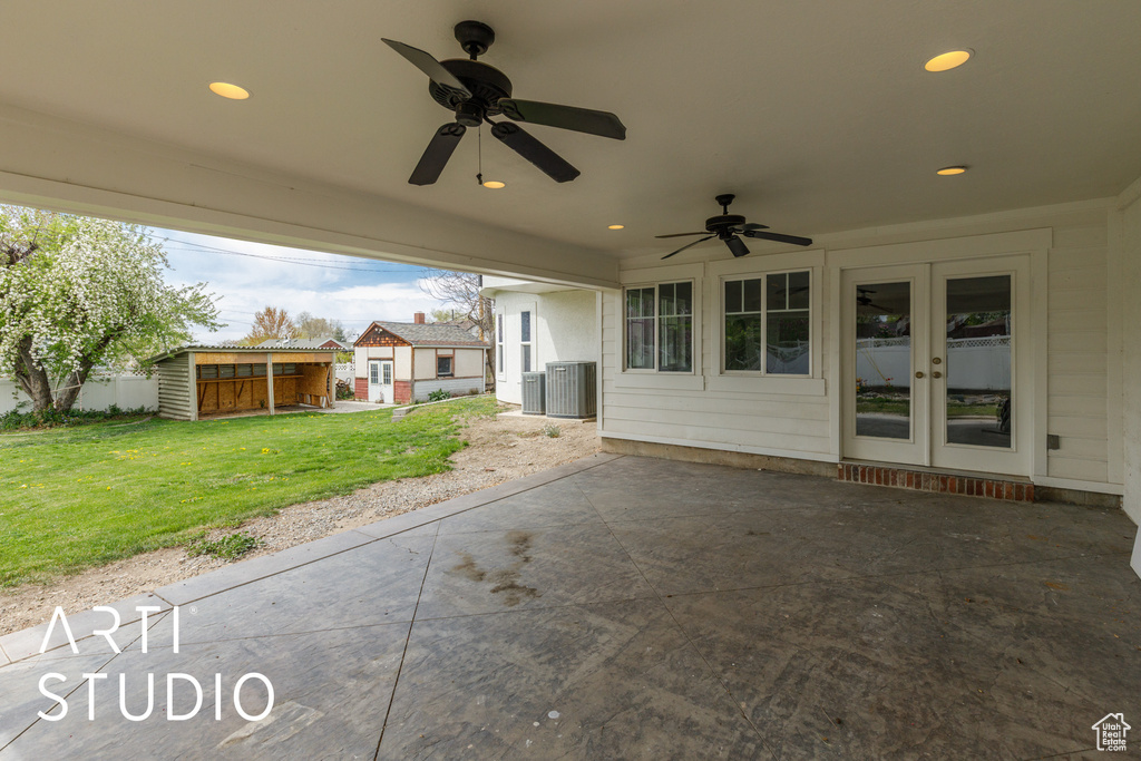 View of patio / terrace featuring central AC unit, a ceiling fan, french doors, and an outbuilding