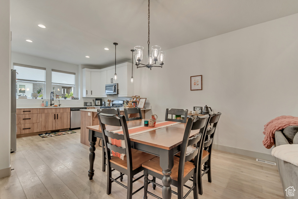 Dining area featuring visible vents, recessed lighting, light wood finished floors, a chandelier, and baseboards