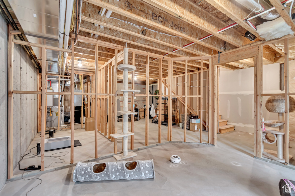 Unfinished below grade area featuring stairway