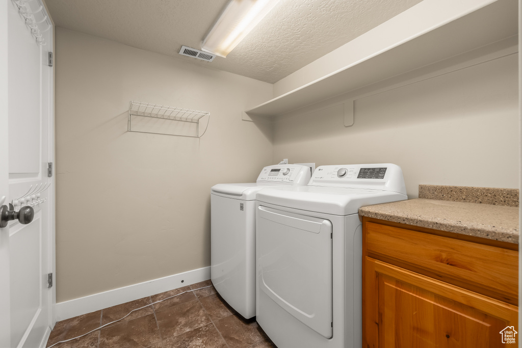 Laundry room featuring baseboards and washer and dryer