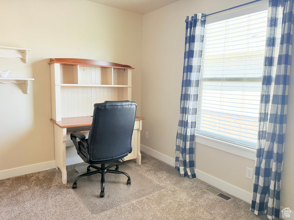 Carpeted office with baseboards