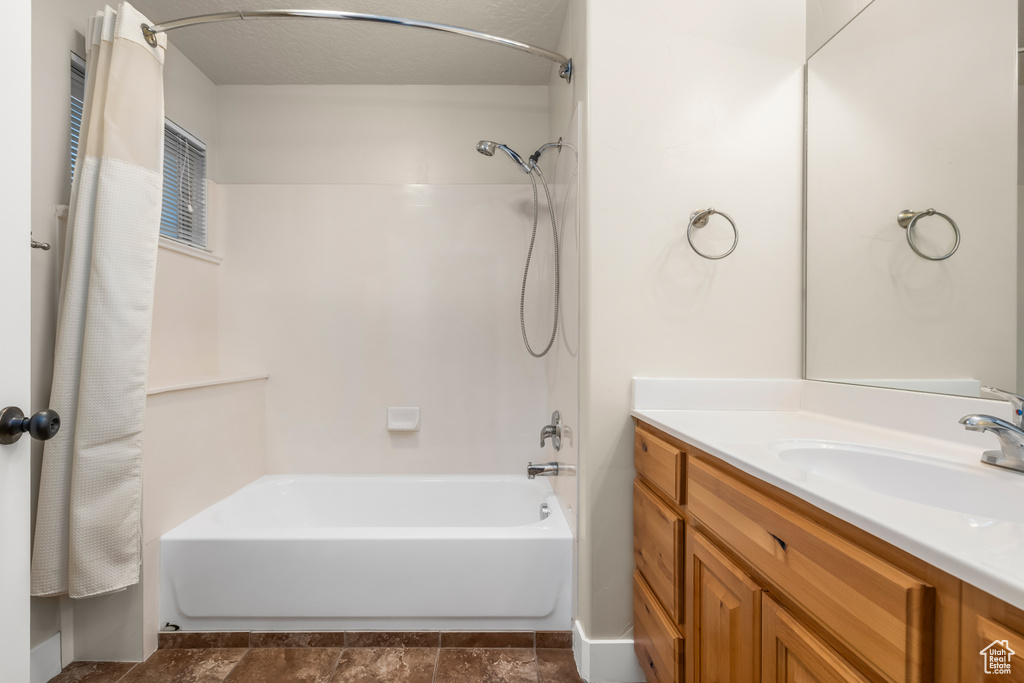 Full bath with shower / bathtub combination with curtain and vanity