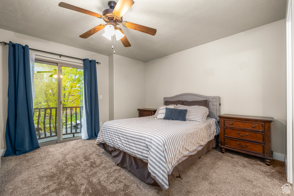 Carpeted bedroom featuring access to outside and ceiling fan