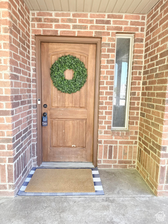 Entrance to property with brick siding