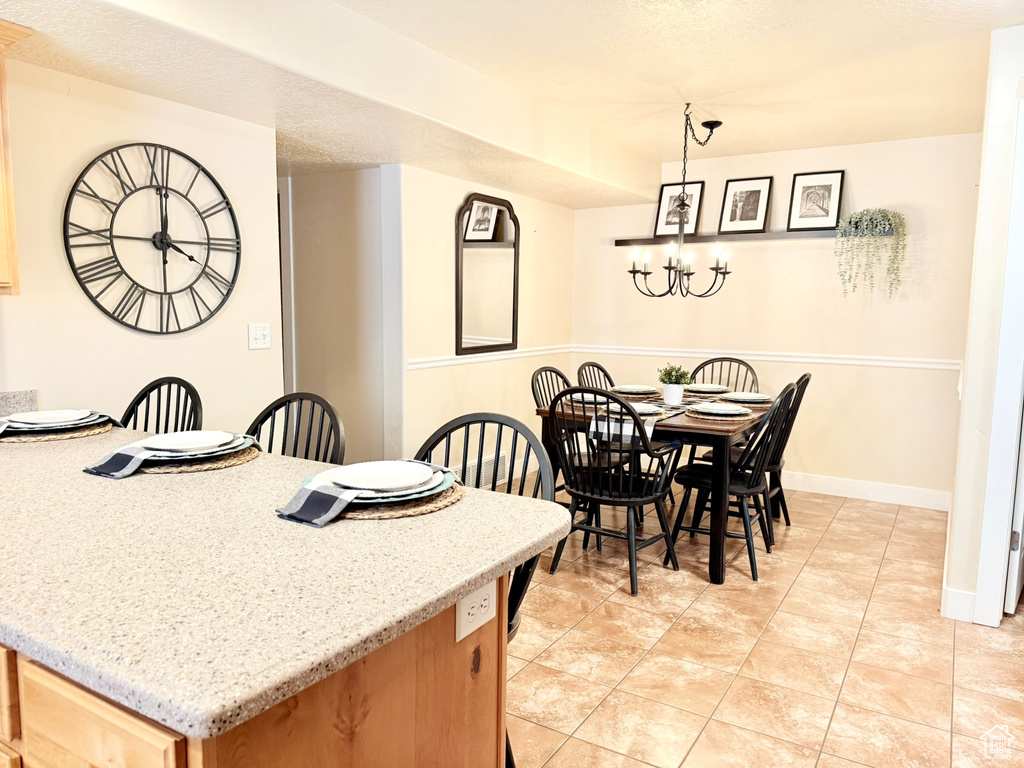 Dining room featuring a chandelier and light tile patterned floors