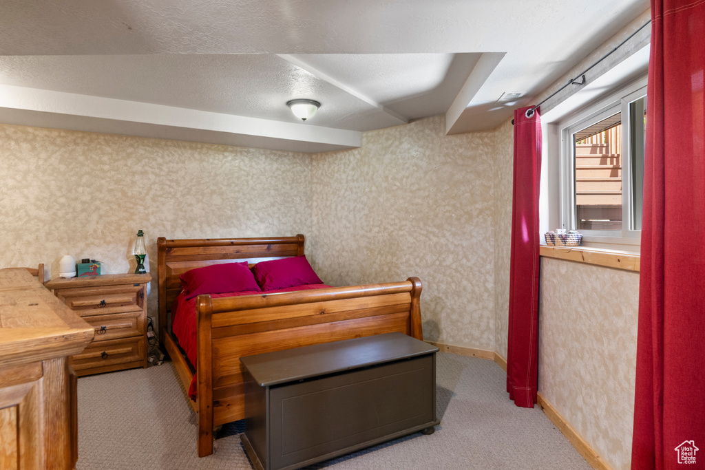 Carpeted bedroom featuring wallpapered walls and baseboards