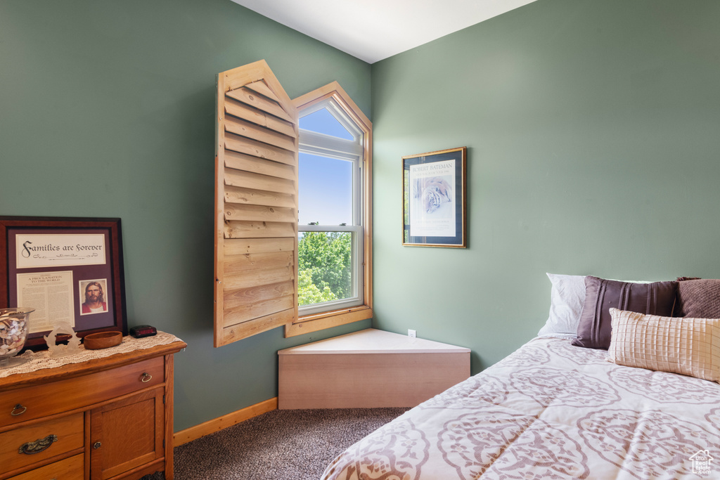 Bedroom featuring carpet flooring and baseboards